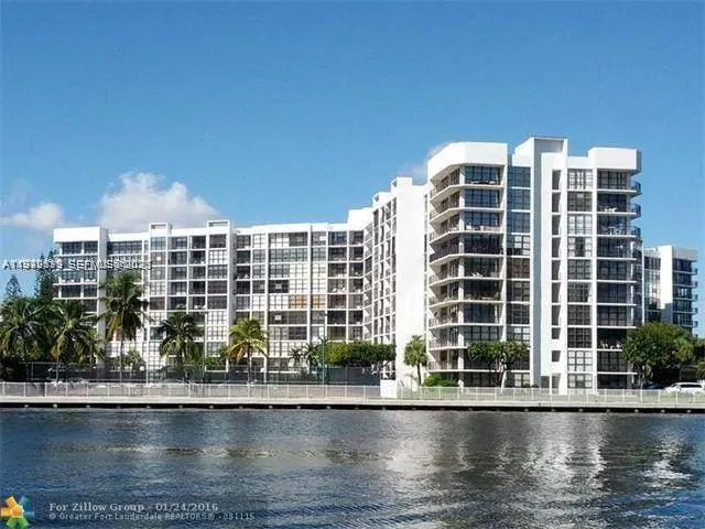 a living room with furniture and a table with kitchen view
