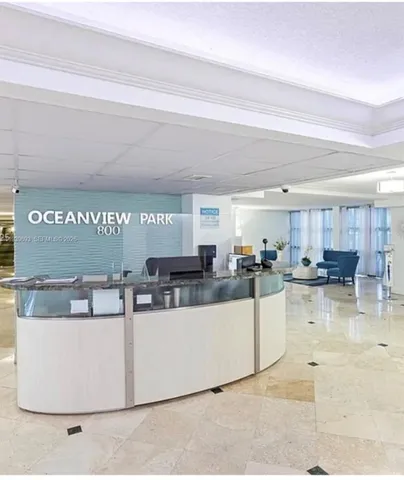 a view of kitchen with kitchen island a sink a stove and a refrigerator with wooden floor