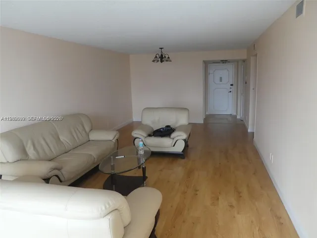 a living room with a couch and a wooden floor