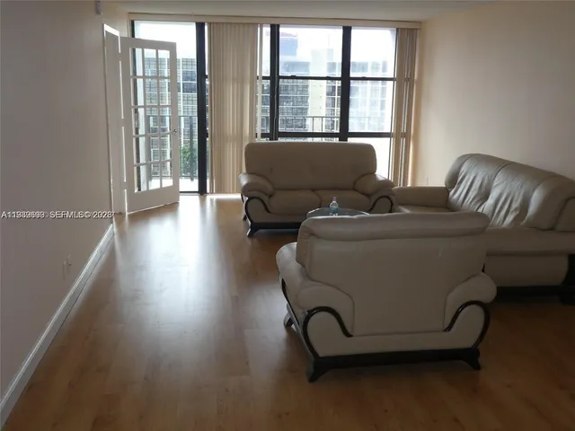 a living room with furniture and a large window