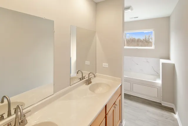 a white bath tub sitting next to a white toilet