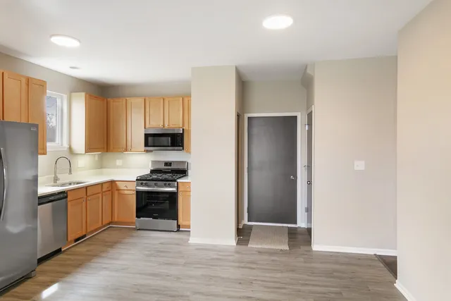 a kitchen with stainless steel appliances granite countertop a stove and a refrigerator