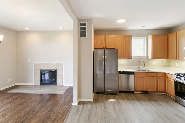 a kitchen with stainless steel appliances granite countertop a refrigerator and a sink