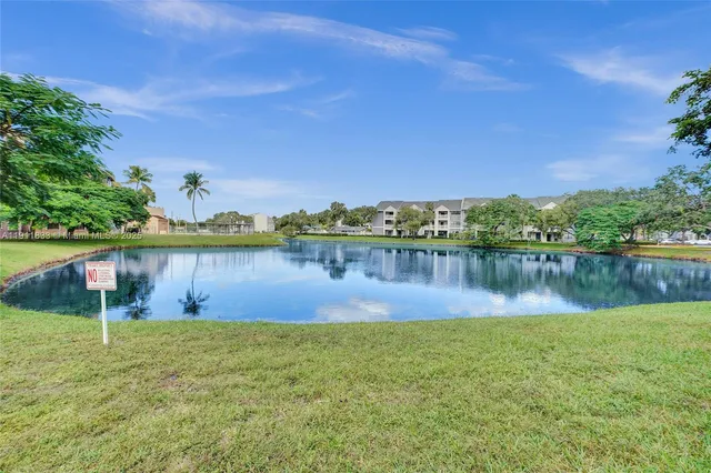 a view of a lake with houses in the back