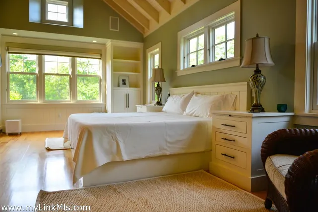a bedroom with a bed and a large window