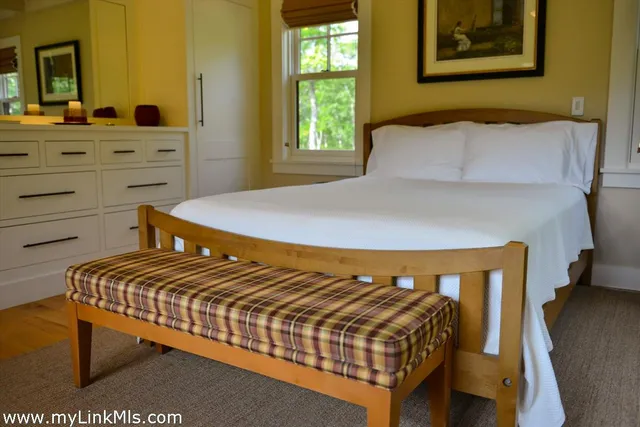 a bedroom with a bed and window