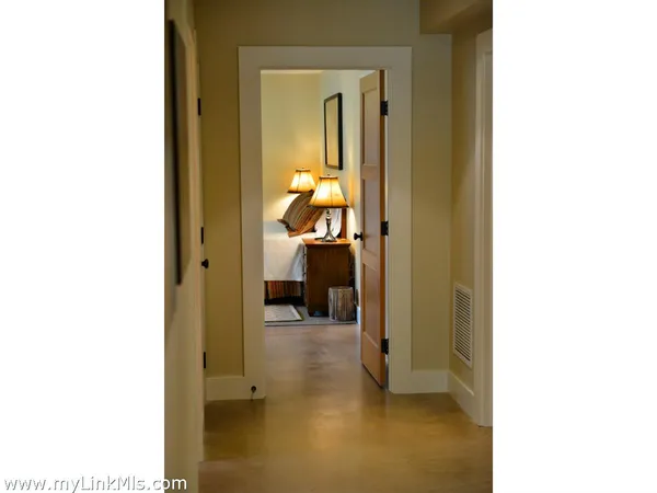 a view of a hallway with bathroom and a room