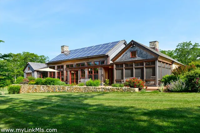 a front view of a house with a garden and plants