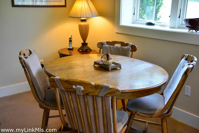 a dining room with furniture and window
