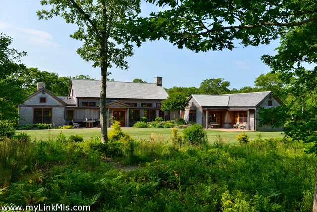 a front view of house with yard and trees