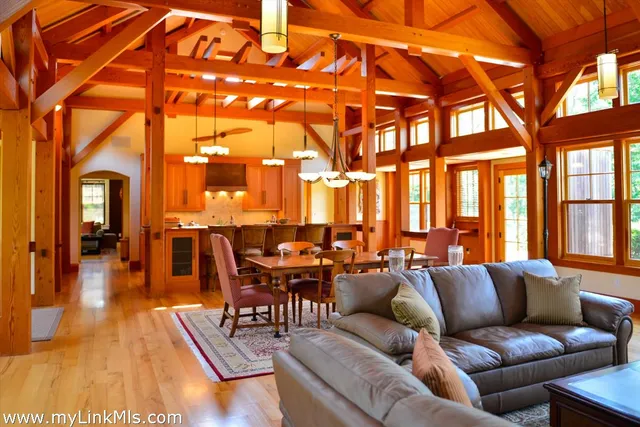 a living room with furniture a city view and large windows