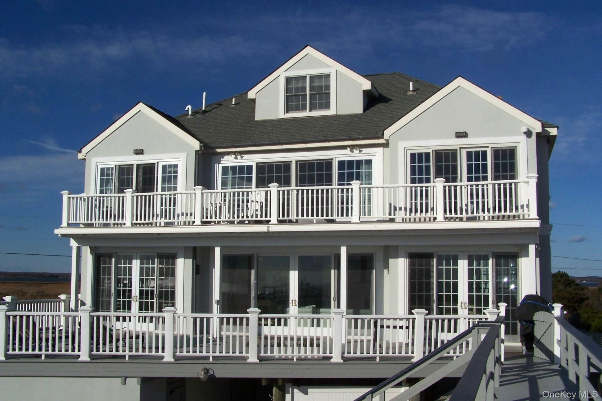 949 B Dune Road West Hampton Dunes, NY 11978 - Photo 15 of 19 Rear view of house with a balcony and french doors