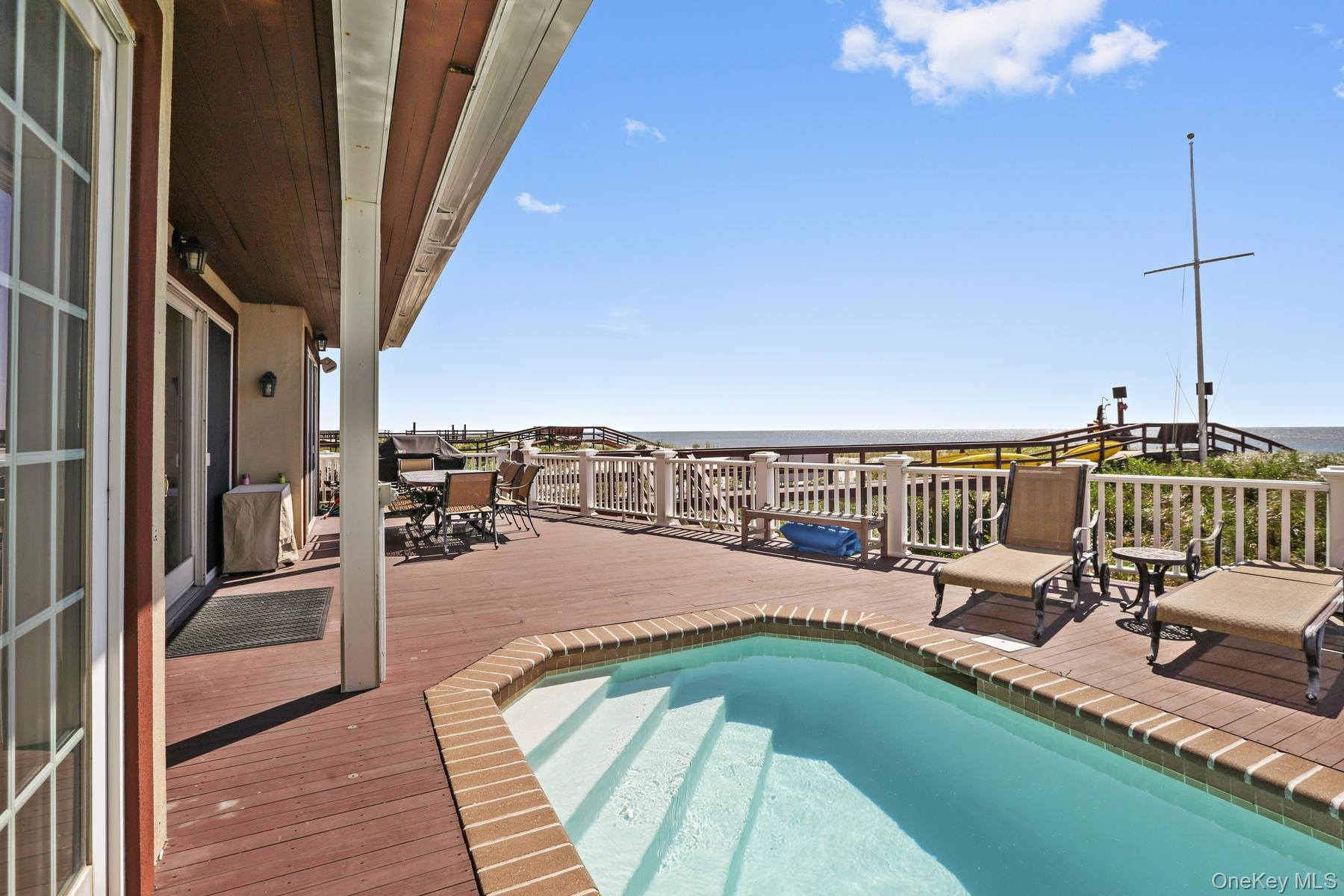 949 B Dune Road West Hampton Dunes, NY 11978 - Photo 16 of 19 View of swimming pool featuring a deck with water view