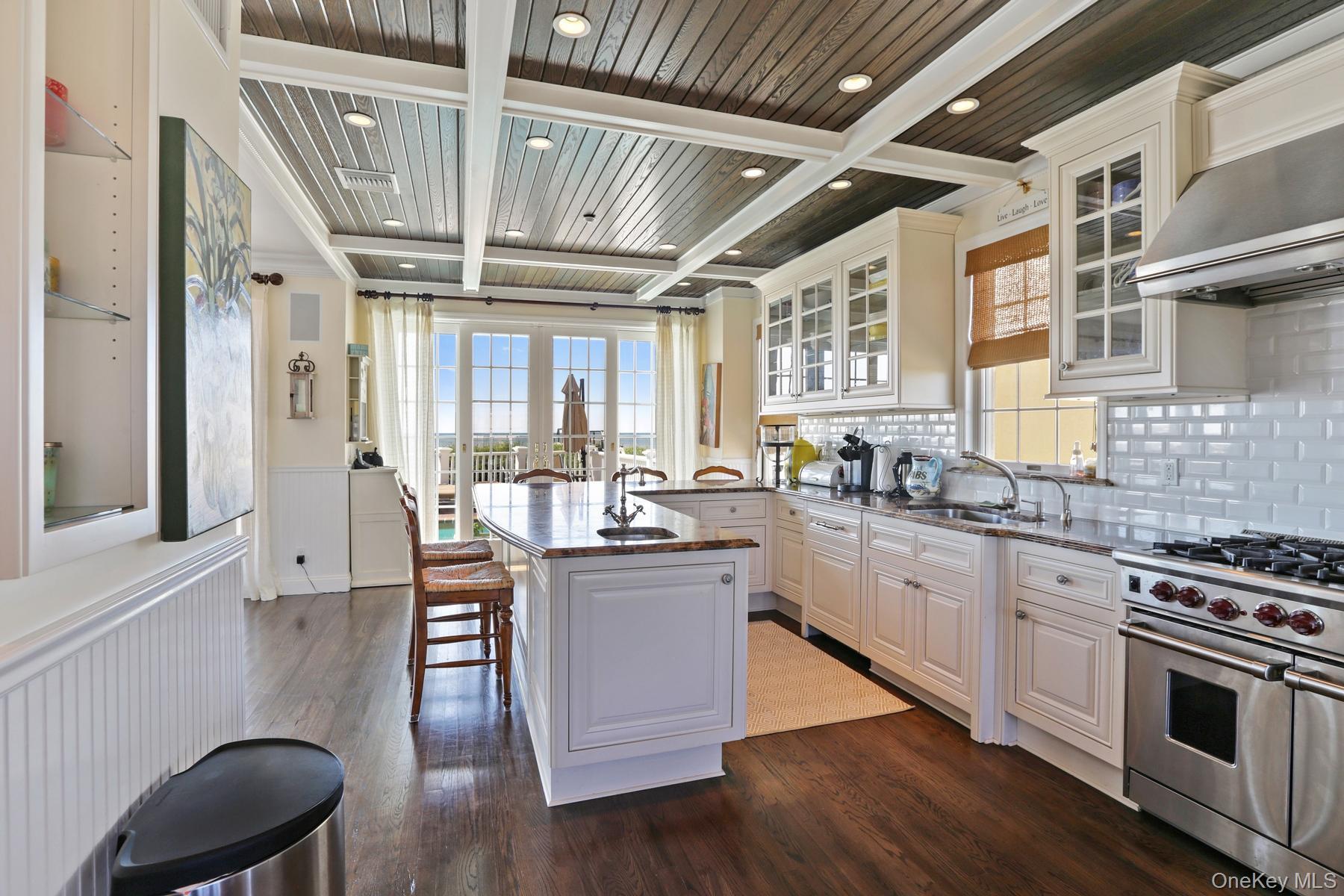 949 B Dune Road West Hampton Dunes, NY 11978 - Photo 4 of 19 Kitchen featuring exhaust hood, sink, white cabinetry, a center island, and double oven range