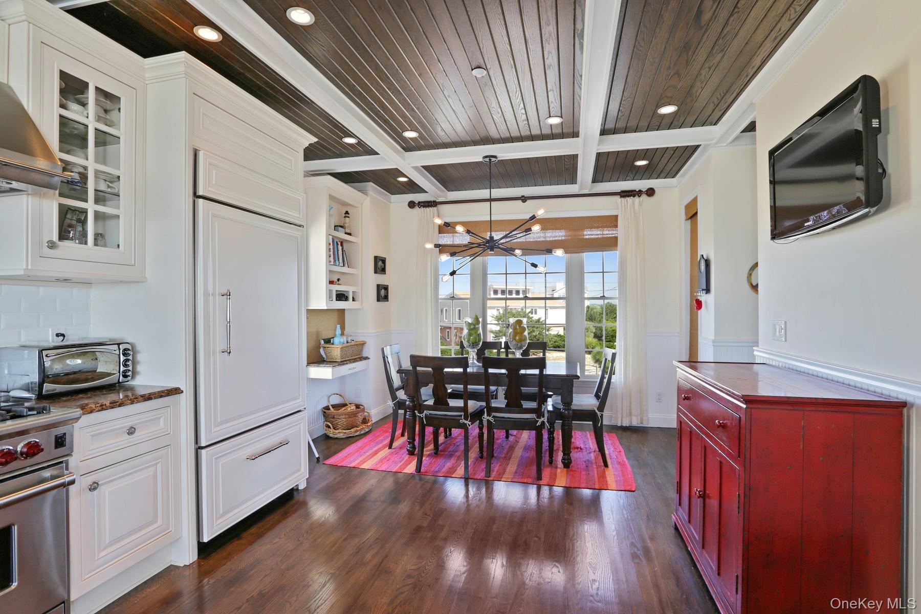 949 B Dune Road West Hampton Dunes, NY 11978 - Photo 5 of 19 Kitchen featuring pendant lighting, dark hardwood / wood-style floors, coffered ceiling, and stainless steel stove