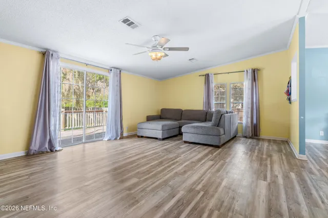 a living room with furniture and kitchen view