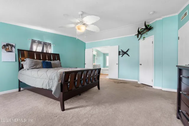 a bedroom with a bed and a dresser