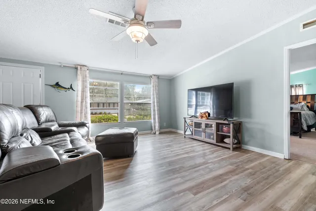 a view of a livingroom with furniture and a ceiling fan