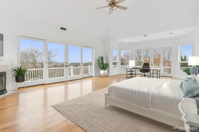 a bedroom with a large bed and a view of living room
