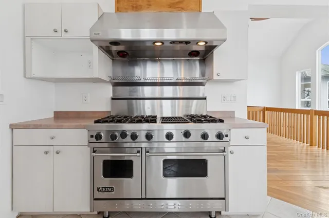 a stove top oven sitting inside of a kitchen