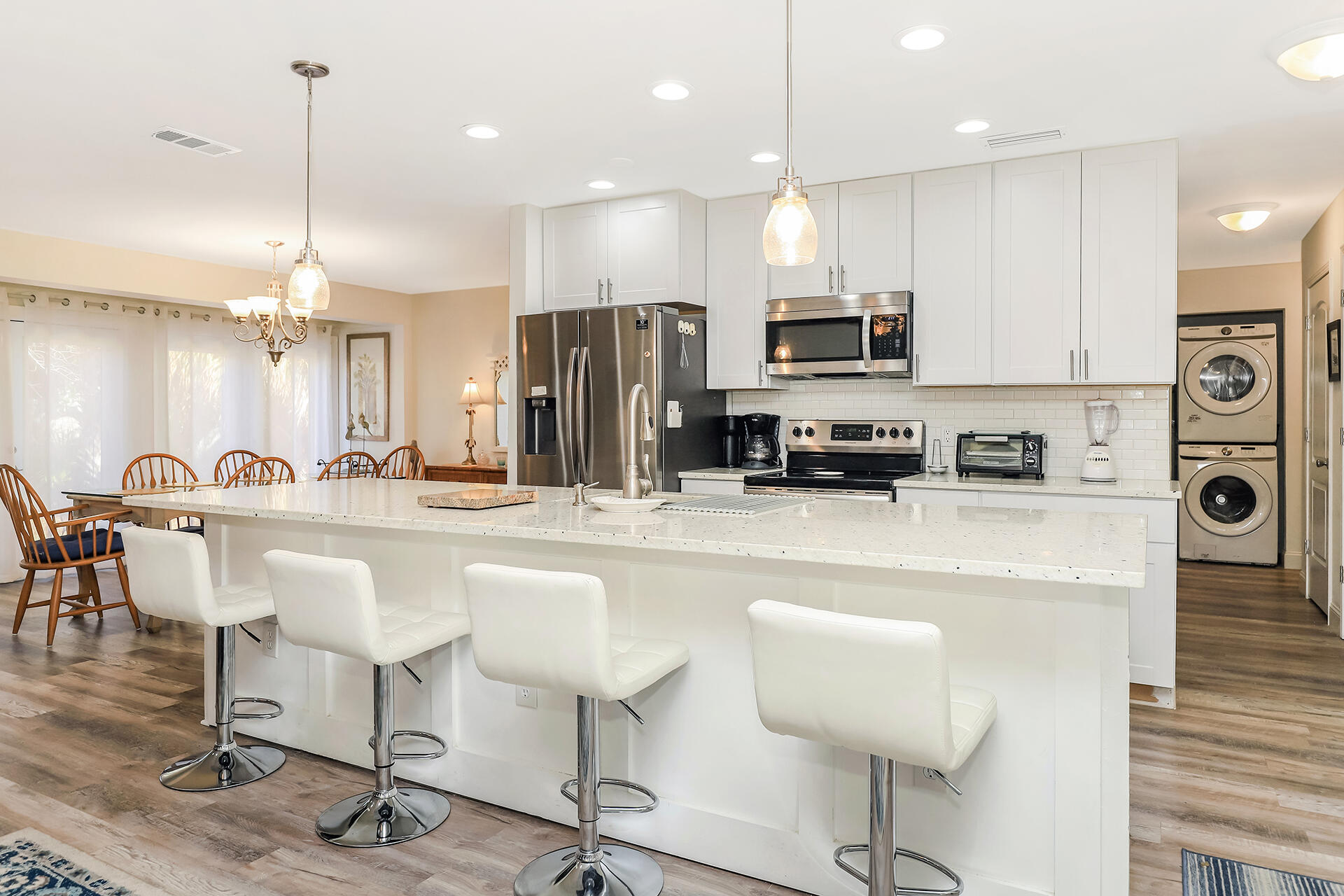 517 Augusta Way, Unit 11001 Miramar Beach, FL 32550 - Photo 2 of 27 a kitchen with stainless steel appliances kitchen island granite countertop a sink and a refrigerator