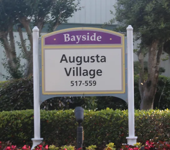 a sign that is sitting on a brick wall