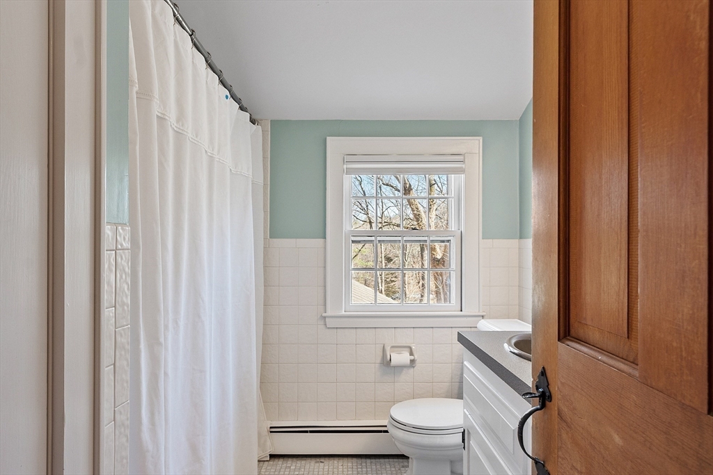 54 Ayer Road Harvard, MA 01451 - Photo 15 of 27 a bathroom with a toilet a sink and a window