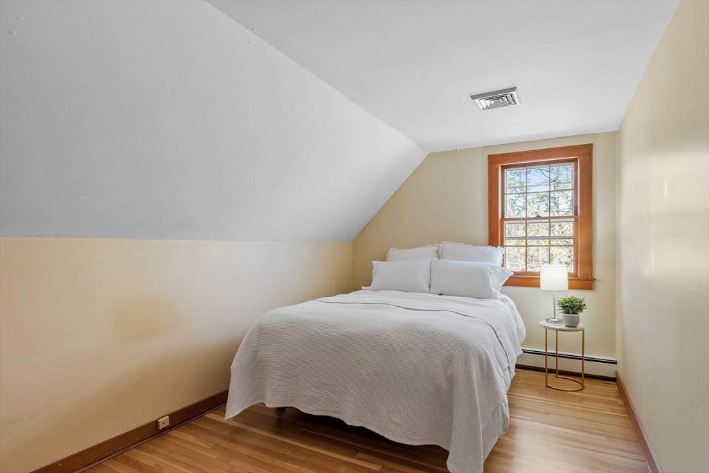 54 Ayer Road Harvard, MA 01451 - Photo 17 of 27 a bedroom with a bed and wooden floor