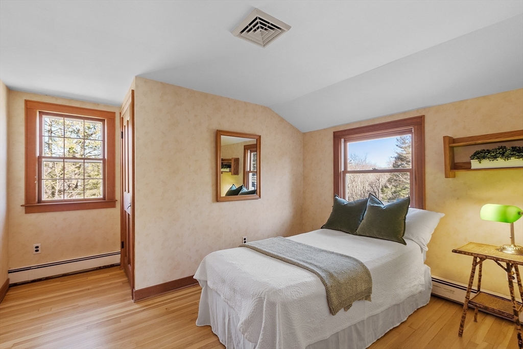 54 Ayer Road Harvard, MA 01451 - Photo 18 of 27 a bedroom with a bed and wooden floor