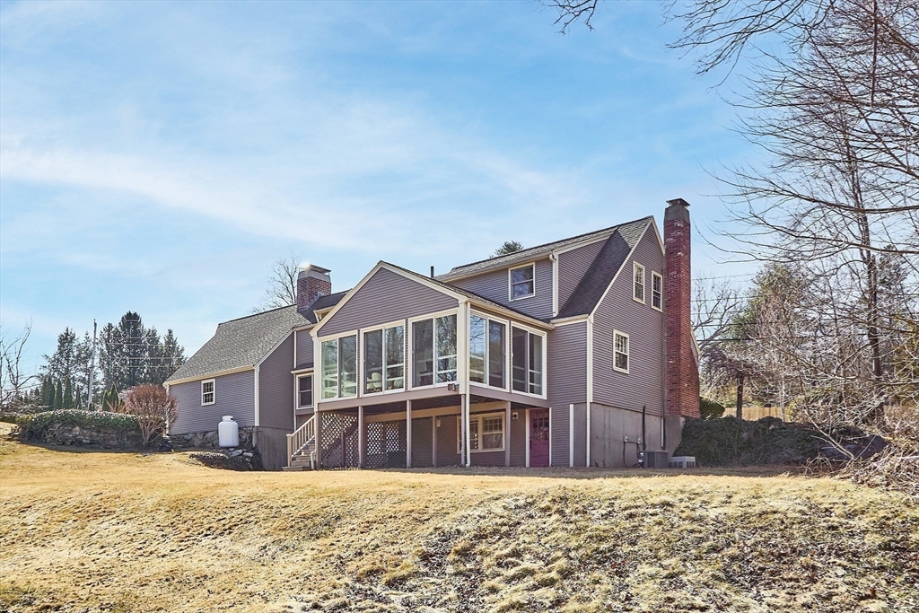 54 Ayer Road Harvard, MA 01451 - Photo 21 of 27 a front view of a house with a yard covered with snow in front of it