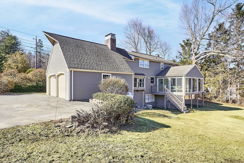 54 Ayer Road Harvard, MA 01451 - Photo 22 of 27 a front view of a house with a yard and garage