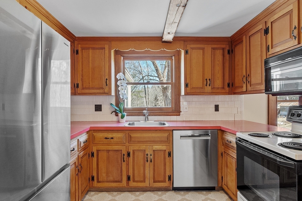 54 Ayer Road Harvard, MA 01451 - Photo 8 of 27 a kitchen with stainless steel appliances a sink stove and cabinets