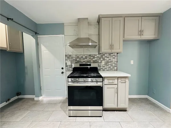 a stove top oven sitting inside of a kitchen
