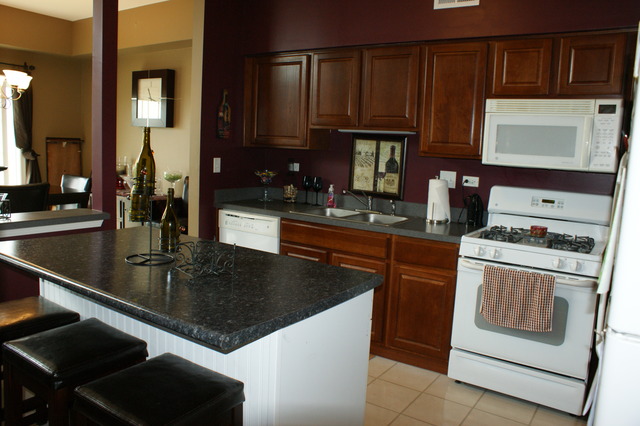 2378 Georgetown Circle Aurora, IL 60503 - Photo 3 of 13 a kitchen with kitchen island granite countertop a sink stove and cabinets