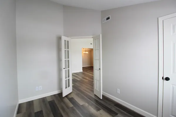 a view of a room with wooden floor