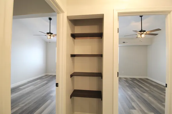 a view of walk in closet with empty racks