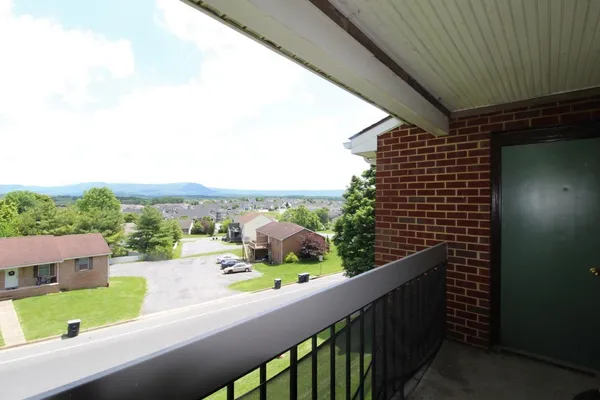 a view of a balcony with an outdoor seating