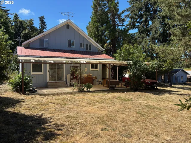 a front view of a house with a yard covered in snow