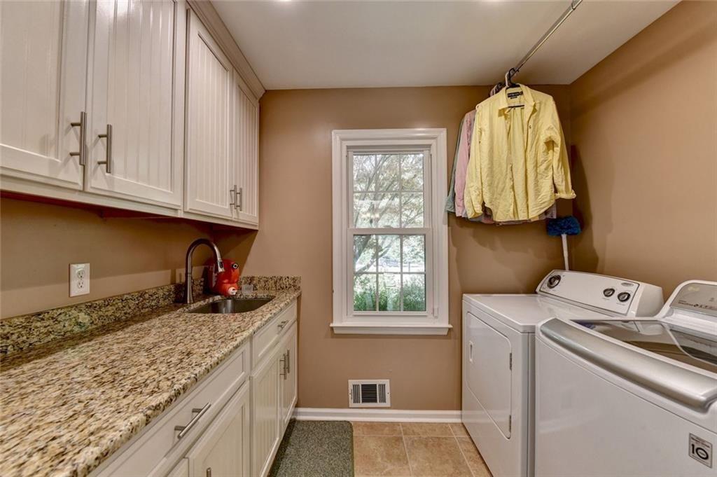 3310 Danielle Way Suwanee, GA 30024 - Photo 11 of 31 a kitchen with a sink cabinets and a window