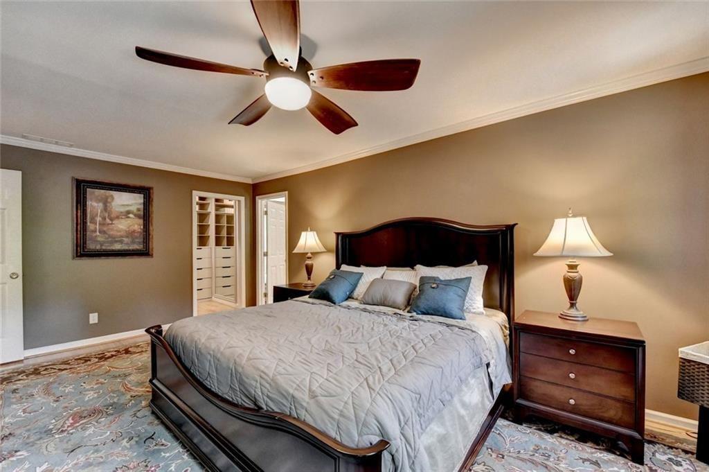 3310 Danielle Way Suwanee, GA 30024 - Photo 13 of 31 a bedroom with a bed and a lamp on dresser