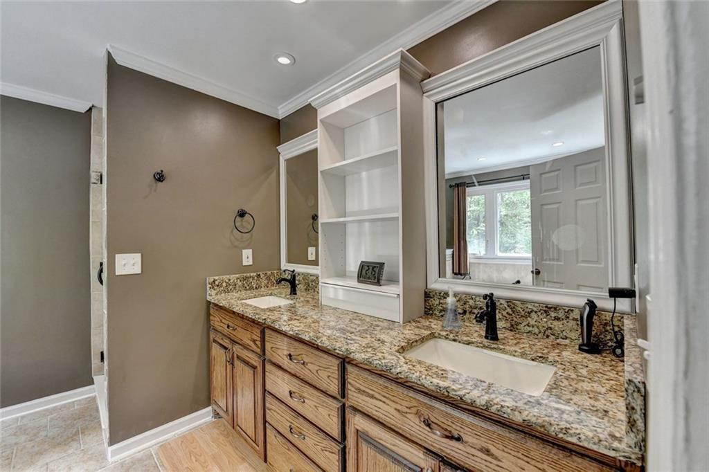 3310 Danielle Way Suwanee, GA 30024 - Photo 15 of 31 a bathroom with a granite countertop sink and a mirror