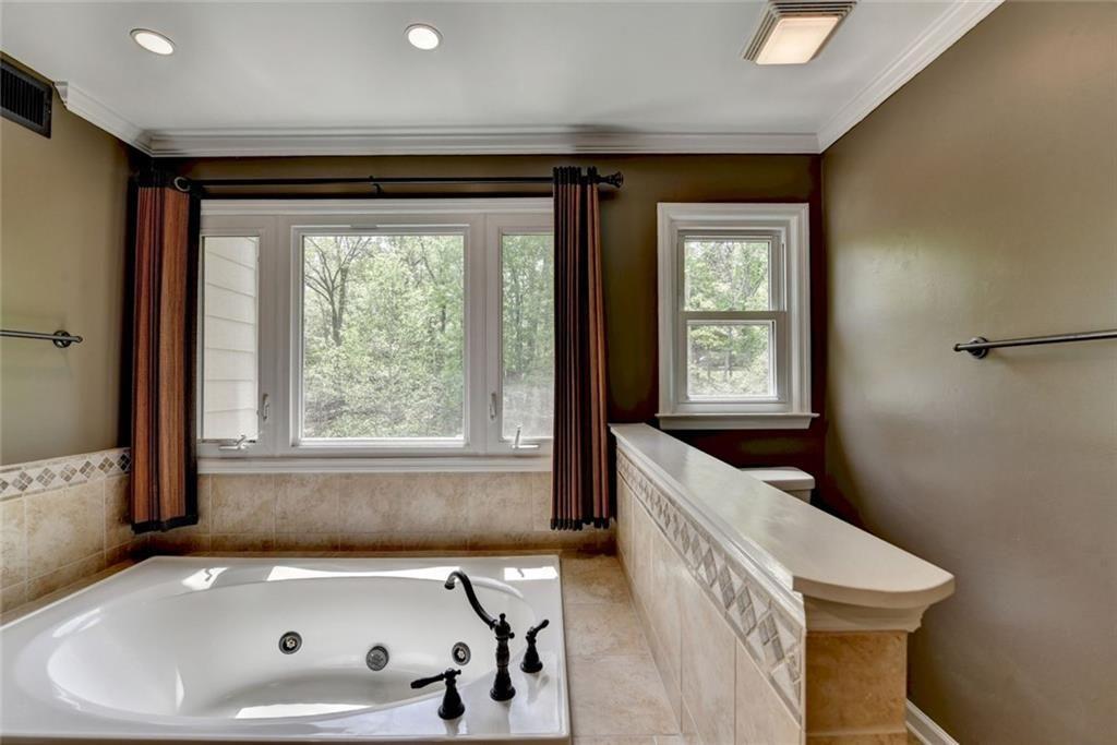 3310 Danielle Way Suwanee, GA 30024 - Photo 16 of 31 a bathroom with a bathtub and a window