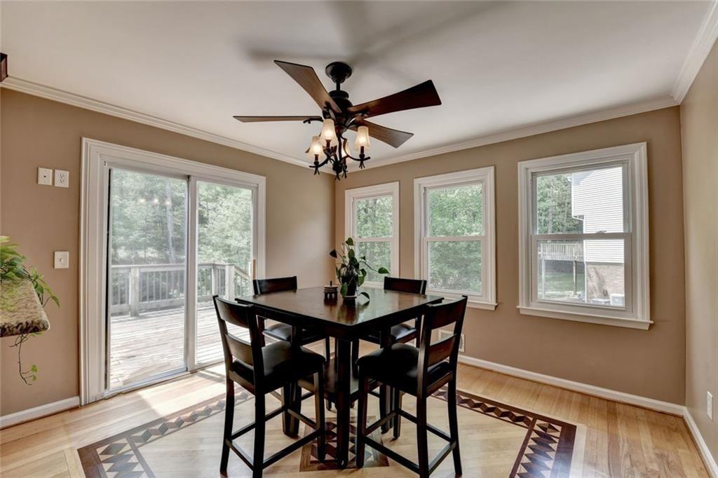 3310 Danielle Way Suwanee, GA 30024 - Photo 9 of 31 a dining room with furniture a chandelier and wooden floor