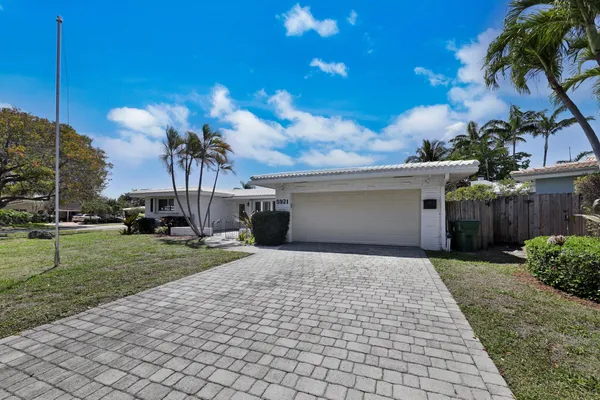 a front view of a house with a yard and a garage