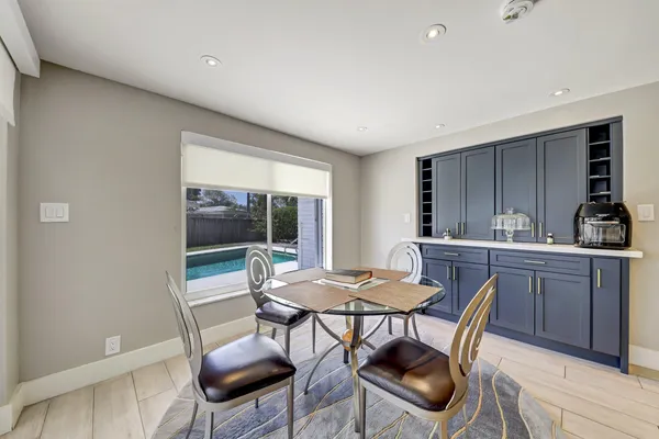 a view of a dining room with furniture and window