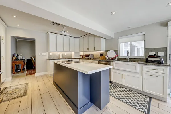 a kitchen with a sink stove and cabinets