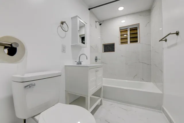 a bathroom with a sink toilet and shower