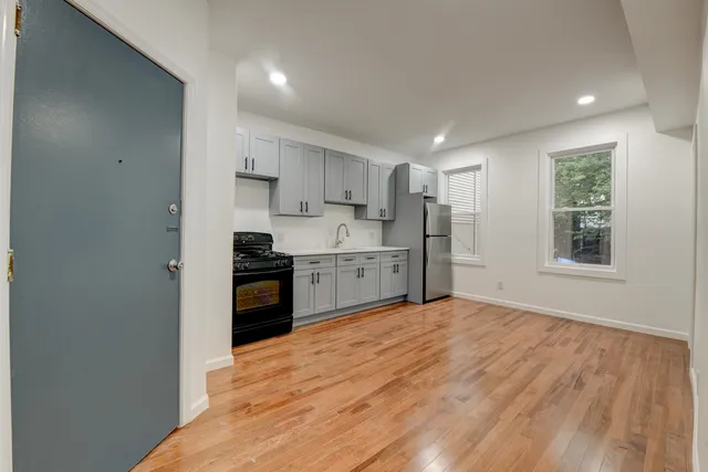 a kitchen with stainless steel appliances granite countertop a stove a sink and a refrigerator