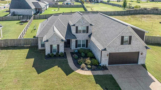 a aerial view of a house with a yard