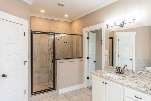 a bathroom with a granite countertop sink shower and a mirror